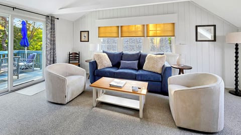 Second floor living room with comfortable seating and slider to deck