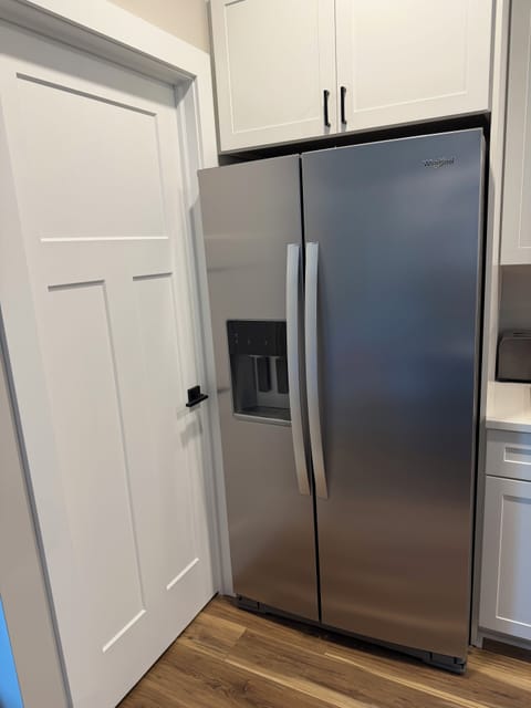 Large side by side refrigerator with water filtration in main floor kitchen.