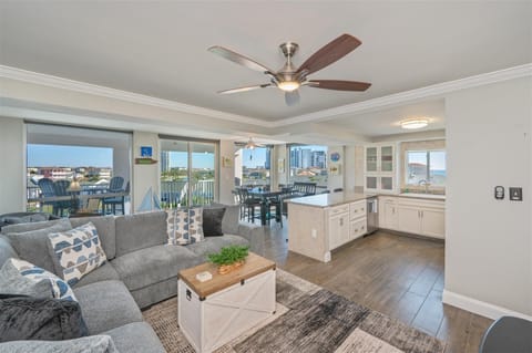 Relax in this open-concept living space where you can unwind on plush sofas while enjoying stunning city views through floor-to-ceiling windows.