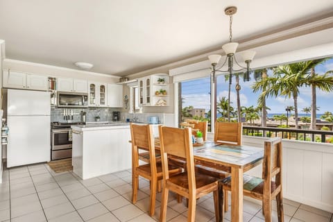 Your bright kitchen flows into a dining space where you'll enjoy meals with stunning tropical views through panoramic windows.