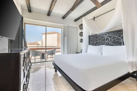 Unwind in a serene king bed with private balcony views.
