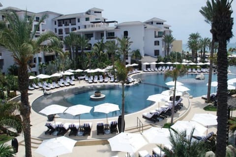 Take in the expansive pool complex framed by swaying palms.