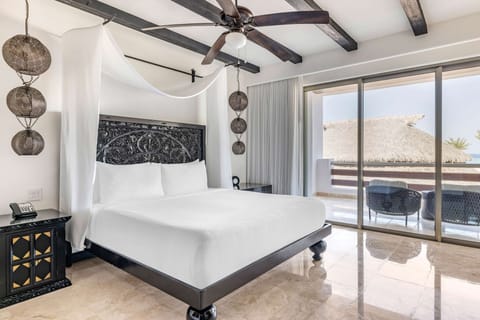 Relax in crisp linens as sunlight pours through the sliders.