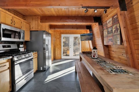 Fully equipped cabin kitchen with ample cabinetry, stove, fridge, microwave, and coffee maker—perfect for cooking meals, morning coffee, and feeling right at home on your stay.