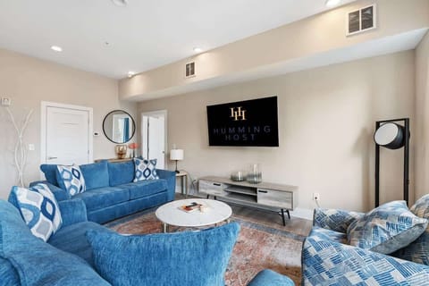 Spacious and bright living room with comfortable seating and modern decor.