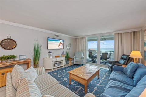 Unwind in your bright oceanfront living room with plush seating, nautical touches, and stunning balcony views that invite endless relaxation.