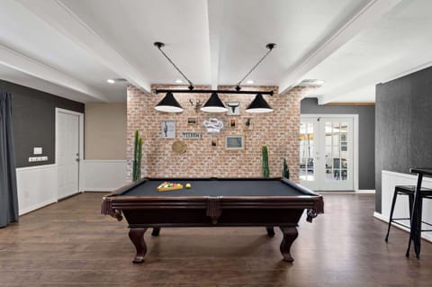 Pool sharks welcome! Rack 'em up in our stylish game room, featuring a classic brick wall and a dash of Western flair.