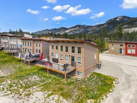 Backyard deck, located off the main living space, with outdoor seating and a BBQ.