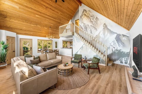 Where Mountain Light Fills the Room – Vaulted pine ceilings and panoramic views, and custom art murals set the tone for peace and connection.