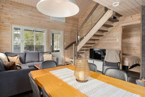 An open living area featuring high ceilings, a stunning tile fireplace, and sleek Scandinavian design.