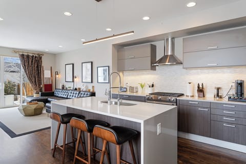 Your sleek modern kitchen features premium appliances and a spacious island perfect for morning coffee or evening meals.