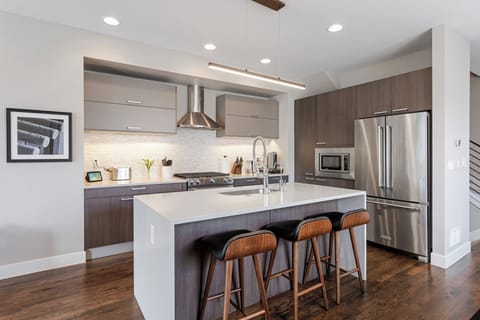 Your sleek modern kitchen features premium appliances, spacious island seating, and everything you need to create memorable meals together.