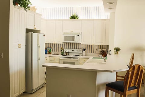 Your fully equipped kitchen awaits with modern appliances and breakfast bar seating for easy meal prep and casual dining.