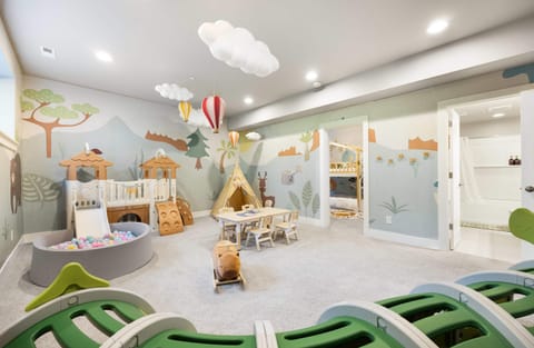 Rocking capibara and activity table encourage varied play, while an adjoining bathroom adds convenience.