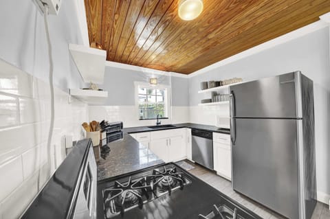 Fully equipped kitchen with gas range and full-size refrigerator.