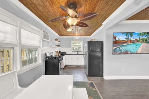 Bright secondary kitchen space with breakfast nook and modern appliances.