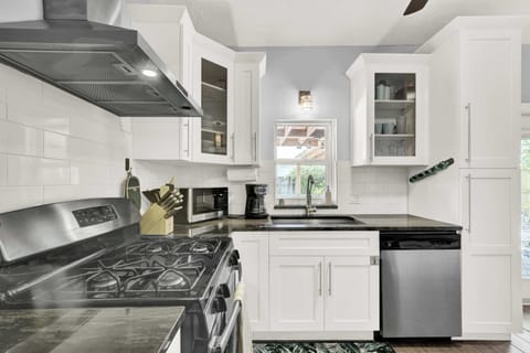 Fully equipped kitchen with gas stove and ample prep space.