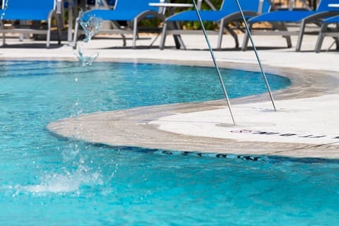 Splash into relaxation with a refreshing dip in the pool, surrounded by comfy loungers.