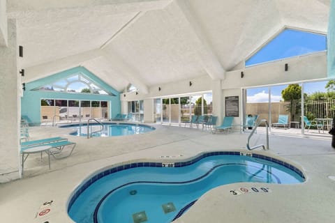 Dive into a spacious indoor pool under soaring skylit ceilings.