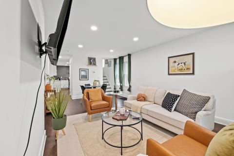 Modern, sunlit living space with a 50” Roku Smart TV, comfortable seating, and dining for 3. Convenient powder bath room on the first floor, Honeywell Home thermostat, and easy self check-in with Schlage Encode smart lock.