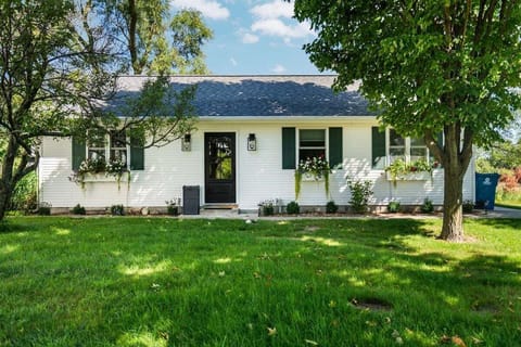 Classic cottage charm with curb appeal 🌿

A welcoming front entry, blooming window boxes, and a peaceful yard surrounded by mature trees.