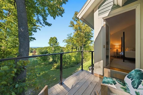 Step directly from the bedroom onto a secluded wooden deck to enjoy fresh air and peaceful surroundings.