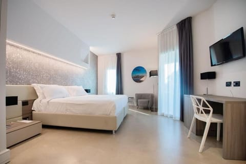 Stretch out in an airy bedroom with relaxing lounge chair.