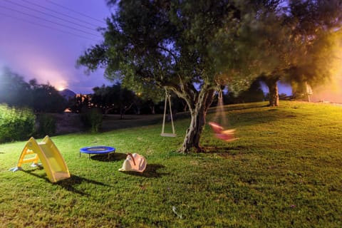 Garden at Night with Ambient Lighting and Open Lawn