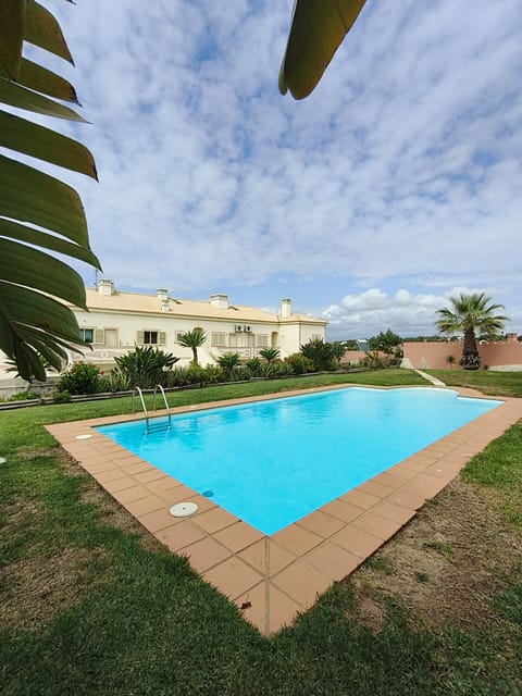 Cool off in the swimming pool at the back of the property