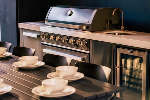 Fire up the BBQ! Our outdoor kitchen has everything you need to grill out.
