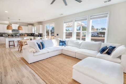 Spacious living room filled with natural light and seamless flow into the kitchen and dining area.