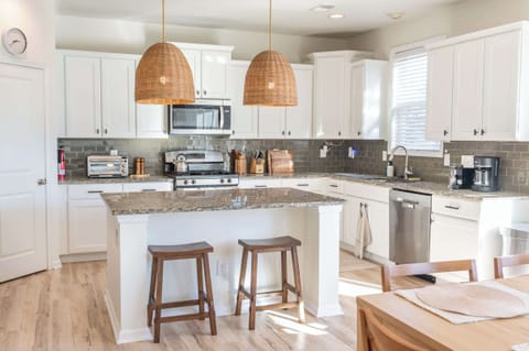 Fully equipped kitchen with granite countertops and bar seating for casual meals.