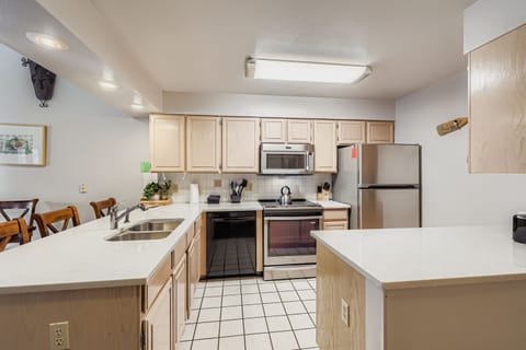 Your fully equipped kitchen awaits with stainless steel appliances and ample counter space for preparing home-cooked meals during your stay.