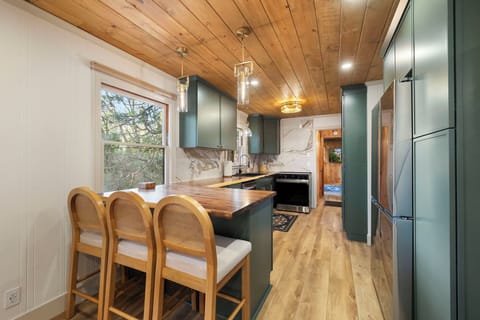 Brand new galley kitchen with peninsula area for seating or serving, full size dishwasher, microwave, stove, oven and oven hood. Plethora of storage. Plenty of glassware, dishes and silverware for your group. Spices and a few kitchen essentials as well.