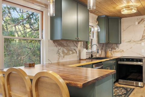 Brand new galley kitchen with peninsula area for seating or serving, full size dishwasher, microwave, stove, oven and oven hood. Plethora of storage. Plenty of glassware, dishes and silverware for your group. Spices and a few kitchen essentials as well.