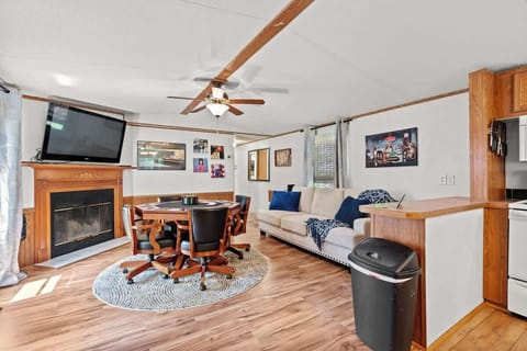 The living room flows seamlessly into the kitchen, creating a warm, social hub for your stay. Relax on the comfy sofa and enjoy a movie on the TV, challenge friends at the poker table, or step outside onto the deck to take in the fresh air and views.