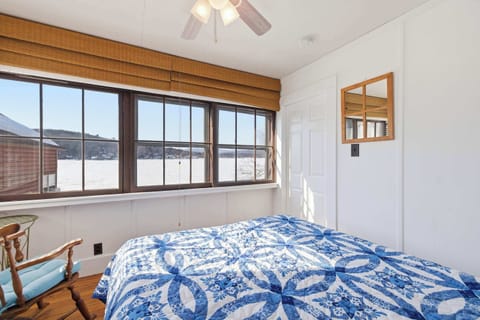 The queen bedroom wakes you up with lake and mountain views through the large picture windows — before you've even reached for your coffee.