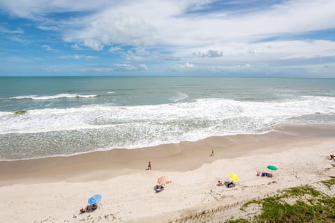 Feel the soft sands beneath your feet as waves gently kiss the shore, inviting you to relax and soak up the sun.