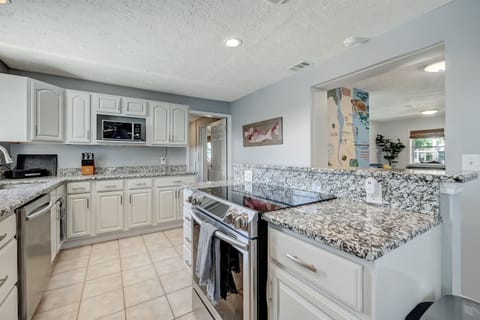 Fully equipped kitchen with granite countertops and stainless appliances.