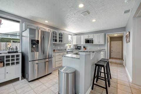 Spacious kitchen with bar seating and open layout.