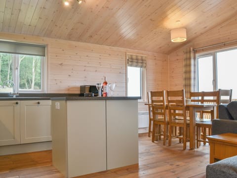 Kitchen and adjacent dining area | Ben Wyvis - Woodland Lodges, Forres, near Nairn