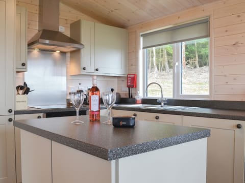 Kitchen area with an island | Ben Wyvis - Woodland Lodges, Forres, near Nairn