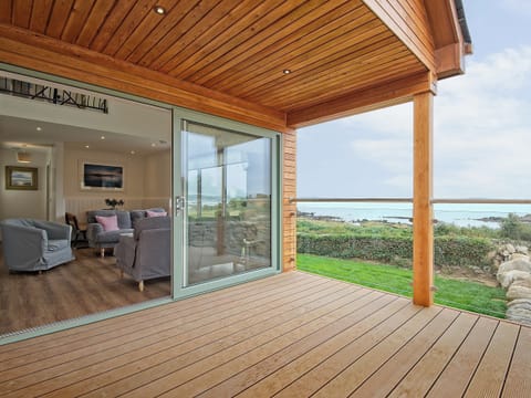 Decked area with access to the open plan living area | Curlew Cottage, Mossyard, near Gatehouse of Fleet