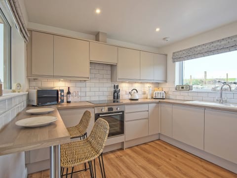 Spacious kitchen with breakfast bar | Curlew Cottage, Mossyard, near Gatehouse of Fleet