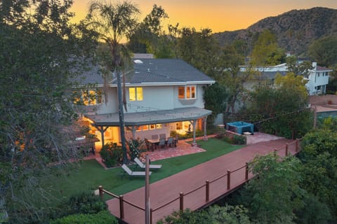 Golden-hour glow at your private retreat—string lights, spacious yard, and effortless indoor-outdoor living.