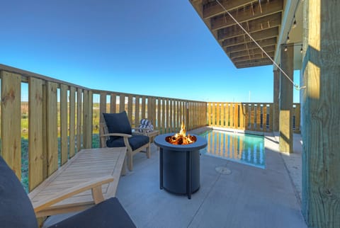 Private patio with pool and firepit—unwind with pond views and coastal breezes from your own outdoor retreat.