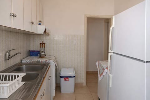 Compact yet practical kitchen and dining area with modern appliances and a refrigerator for longer stays.