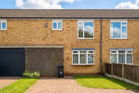 Your home for the stay, a spacious terraced house with a private driveway and garage.