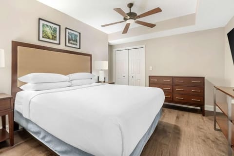 Stretch out and recharge in a calm, coastal bedroom.