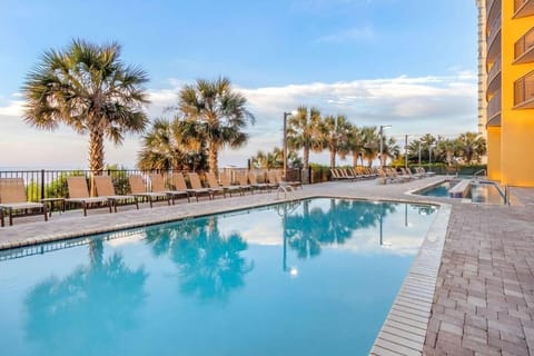 Unwind poolside beneath palms with plenty of loungers.